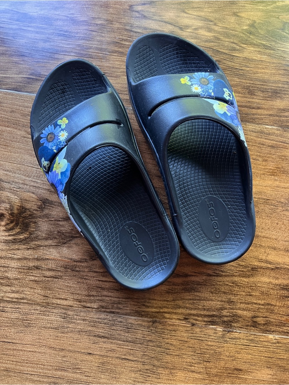 OOFOS Black Slide Sandals with Blue & Yellow Floral Accents